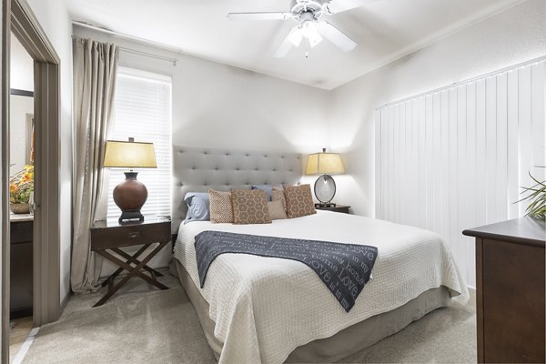Elegant bedroom with large windows and modern furnishings at The Monterra Apartments, luxury living offered by Greystar