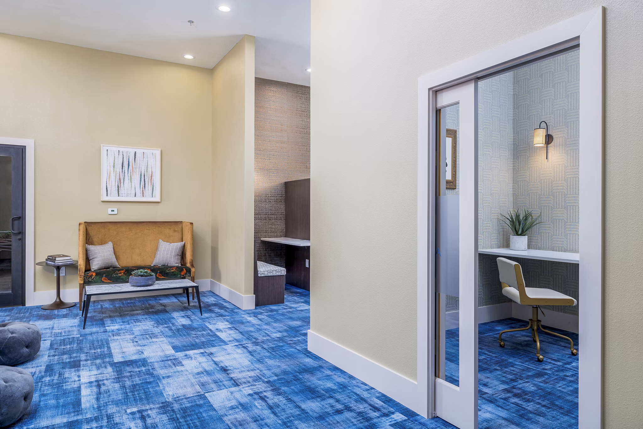 Contemporary business center with meeting tables and computers at The Monterra Apartments clubhouse