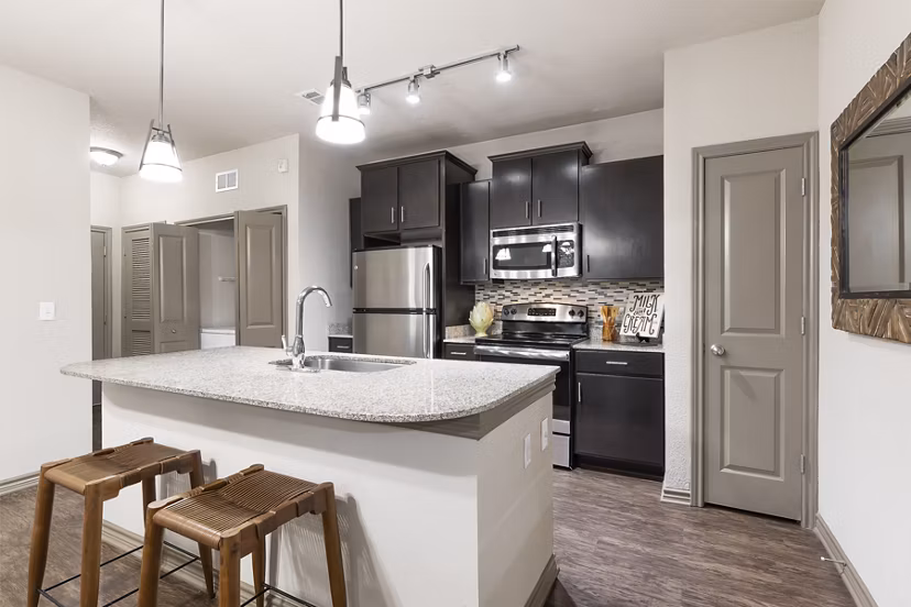 Modern kitchen with stainless steel appliances in The Monterra Apartments