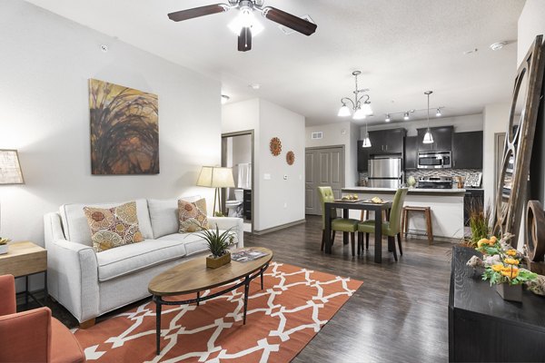 Living room with modern decor and large windows at The Monterra Apartments in a vibrant  community