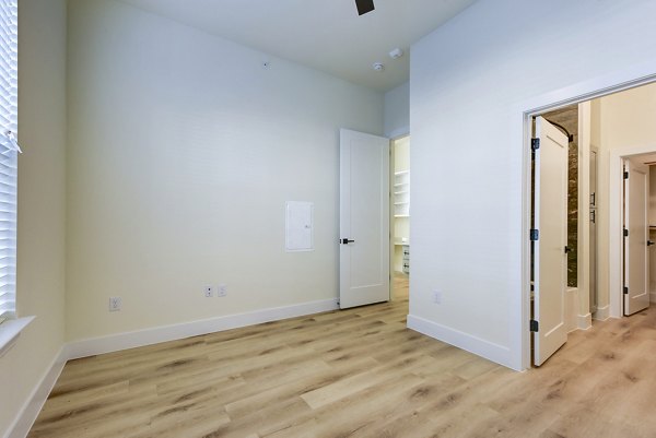 Elegant bedroom with modern furnishings at The Tobin Estate Apartments