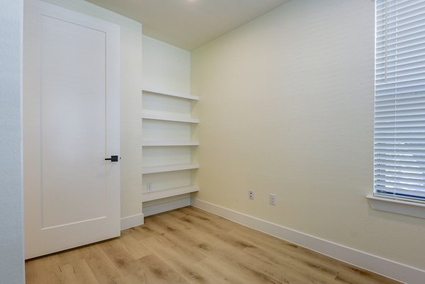 Spacious bedroom with modern design and natural light at The Tobin Estate Apartments