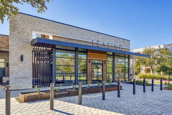 Clubhouse lounge with modern seating and light fixtures at The Tobin Estate Apartments