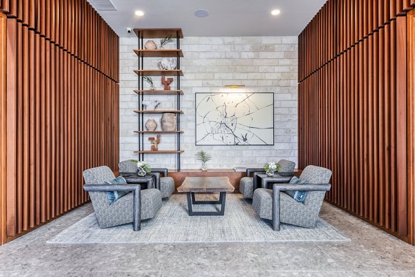 The Tobin Estate Apartments: Elegant clubhouse lobby with modern decor and cozy seating in San Antonio