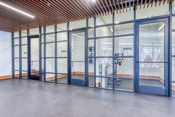 Modern fitness center with state-of-the-art equipment at The Tobin Estate Apartments, offering residents a healthy lifestyle option