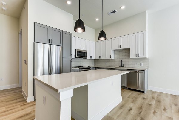 Modern kitchen with stainless steel appliances at The Tobin Estate Apartments