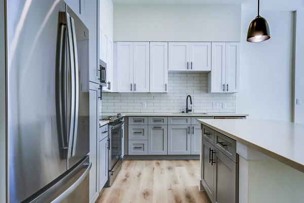 Modern kitchen with stainless steel appliances at The Tobin Estate Apartments