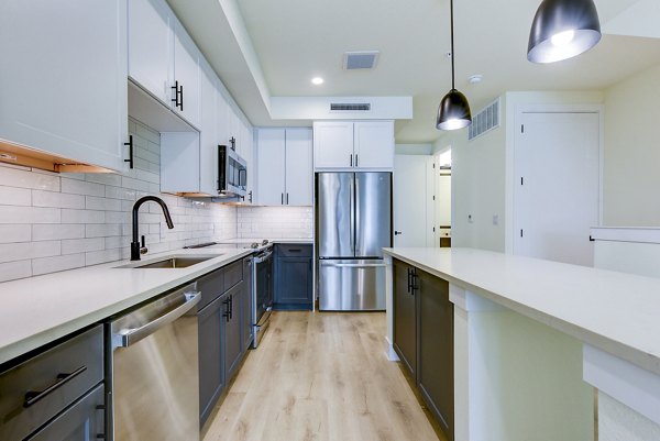 Modern kitchen featuring sleek countertops and stainless steel appliances at The Tobin Estate Apartments