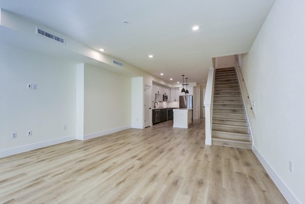 Spacious living room with modern dÃ©cor in The Tobin Estate Apartments