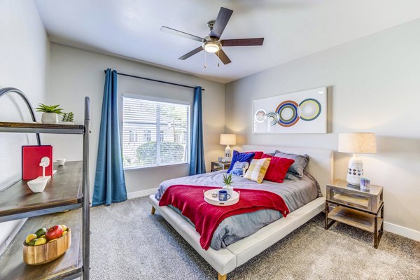 Inviting bedroom with modern decor at Sunstone Apartments, offering luxury living spaces by Greystar