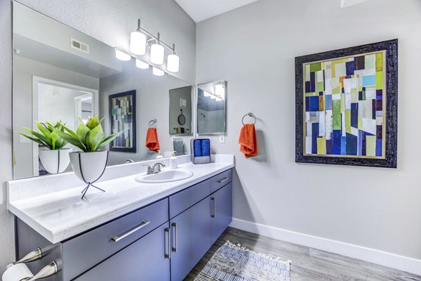 Modern bathroom featuring sleek fixtures and bright lighting at Sunstone Apartments luxury apartments