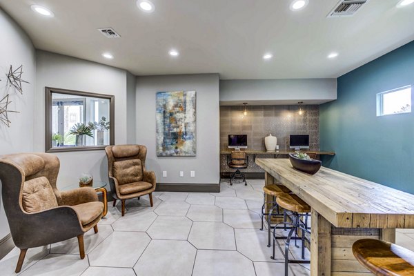 Clubhouse business center with modern workstations at Sunstone Apartments, ideal for productivity and collaboration