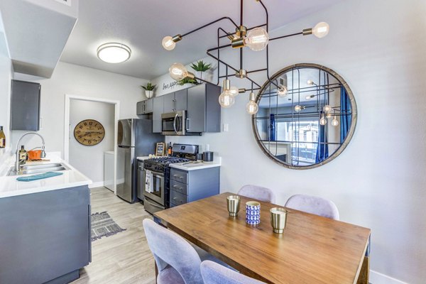 Elegant dining room with modern decor and large windows at Sunstone Apartments, a luxury living space in vibrant neighborhood
