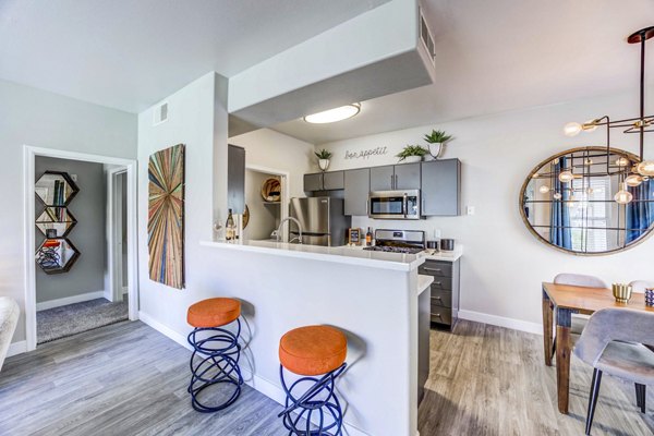 Contemporary kitchen with stainless steel appliances at Sunstone Apartments