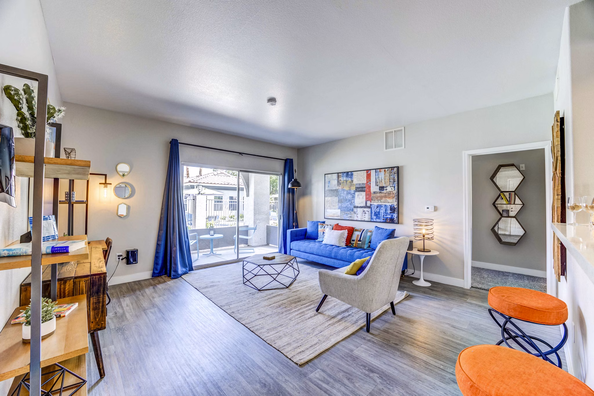 Spacious living room with modern decor and natural light at Sunstone Apartments