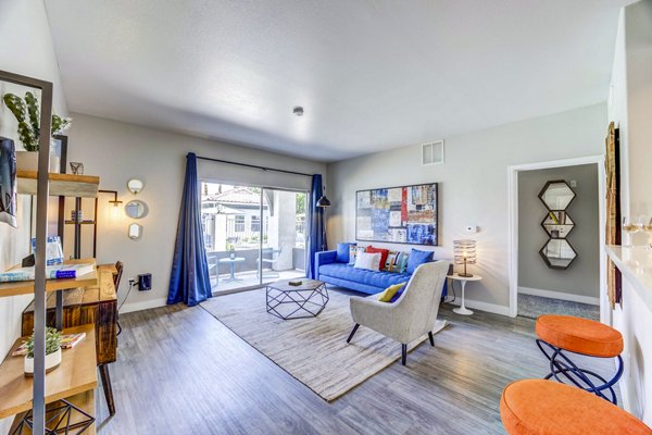 Spacious living room with modern decor and natural light at Sunstone Apartments