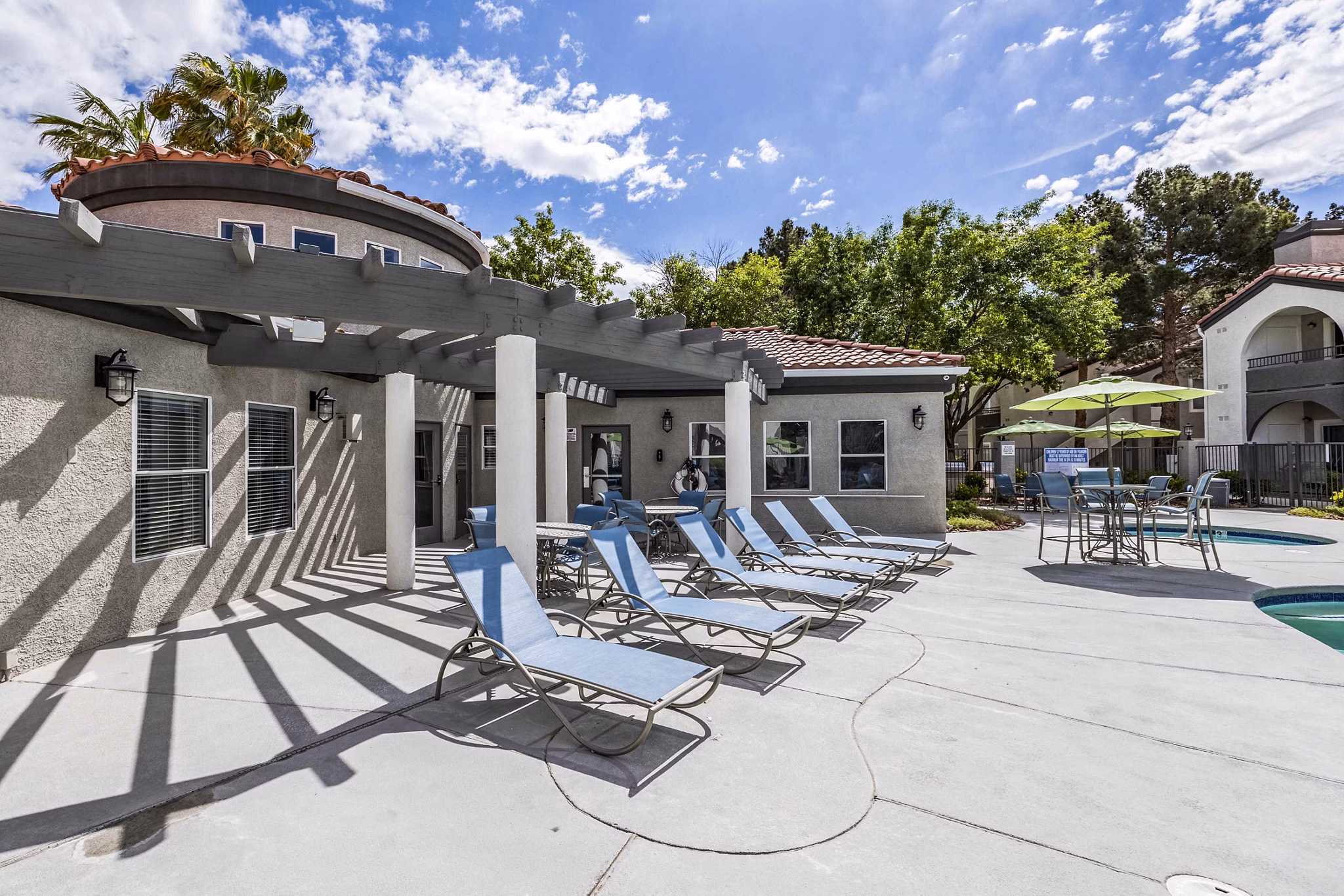 Outdoor pool with stylish patio at Sunstone Apartments luxury living