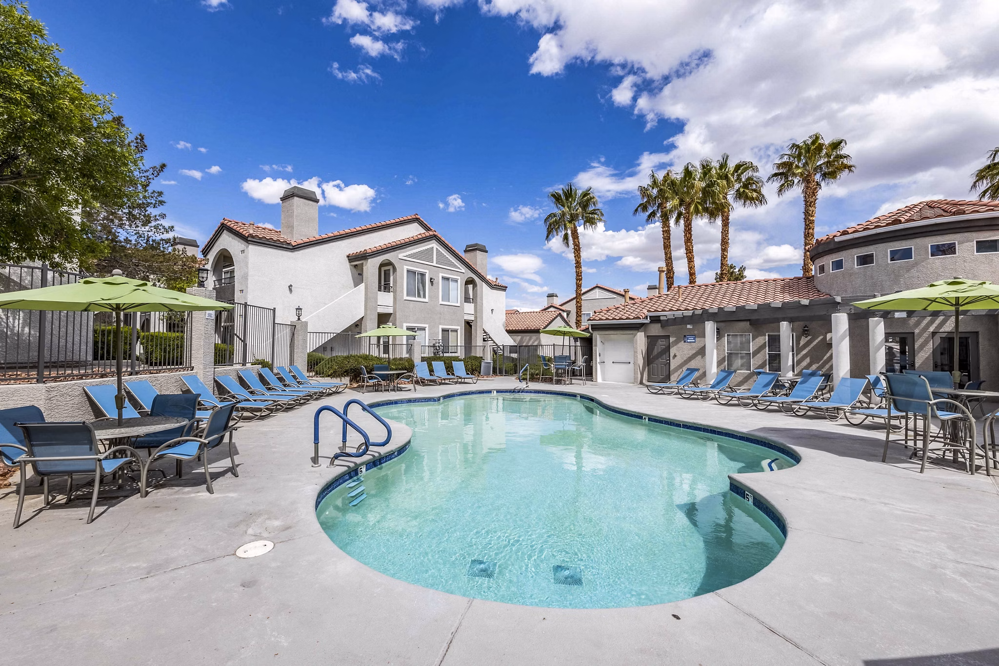 Sunstone Apartments: Outdoor pool with sun loungers and landscaped gardens, luxury living in a vibrant community