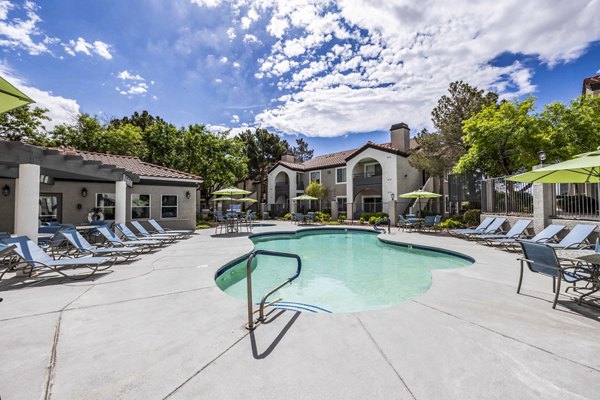 Sunny outdoor pool with lounge chairs at Sunstone Apartments offering luxury leisure