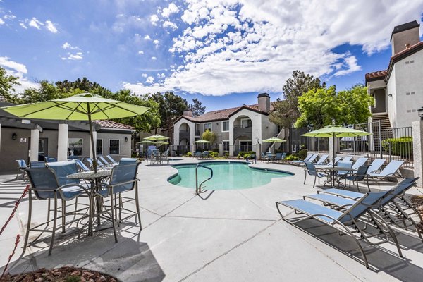 Resort-style pool with sun loungers at Sunstone Apartments, perfect for luxury living and relaxation