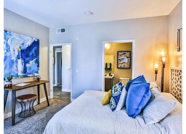Cozy bedroom with modern decor at Solitude at Centennial Apartments
