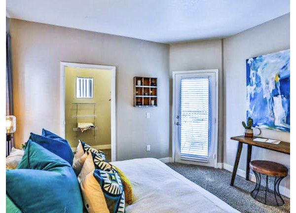 Spacious bedroom with modern decor at Solitude at Centennial Apartments
