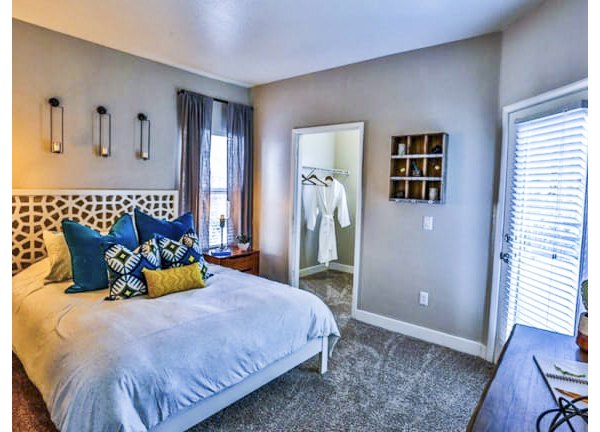 Comfortable bedroom with modern decor at Solitude at Centennial Apartments