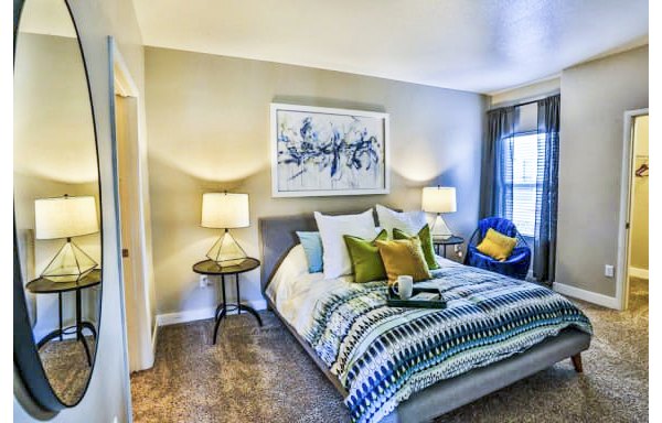 Spacious bedroom with modern decor at Solitude at Centennial Apartments