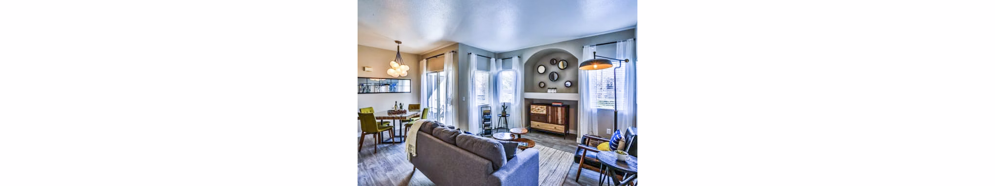 Spacious living room with modern dÃ©cor at Solitude at Centennial Apartments