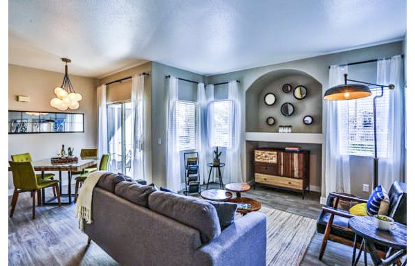 Spacious living room with modern dÃ©cor at Solitude at Centennial Apartments