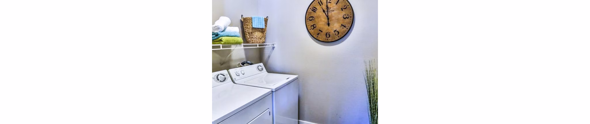 Laundry room with modern appliances at Solitude at Centennial Apartments