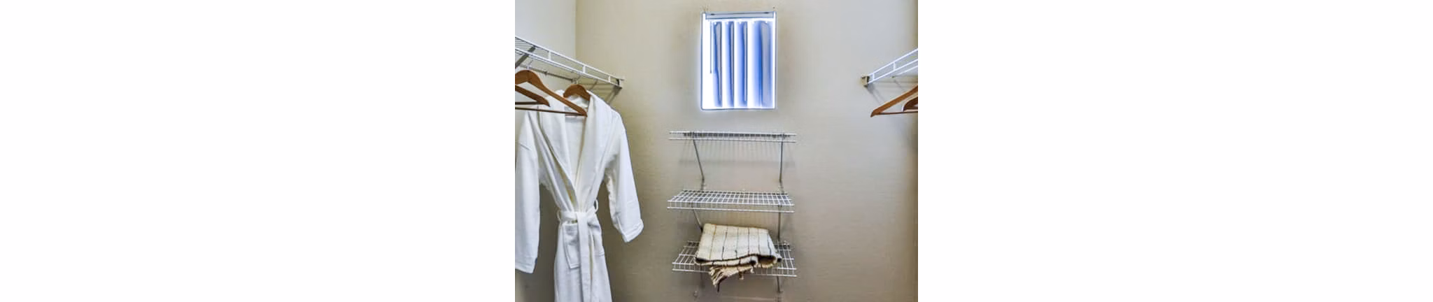 Spacious bedroom closet with built-in shelving at Solitude at Centennial Apartments