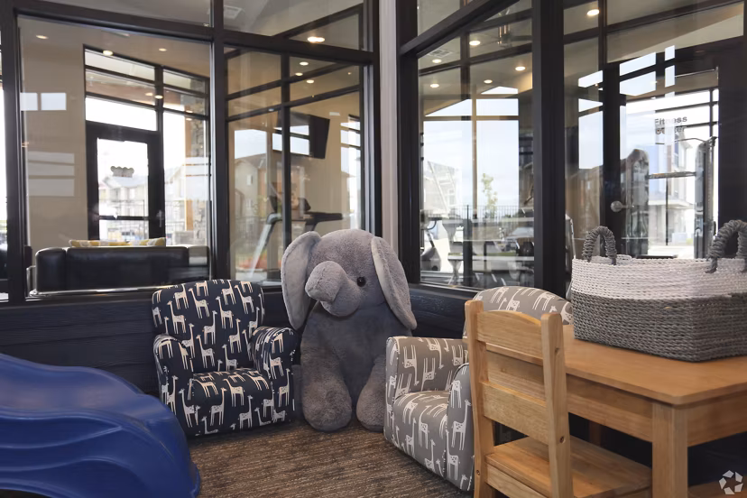Modern clubhouse featuring lounge and entertainment area at Central Park Commons Apartments