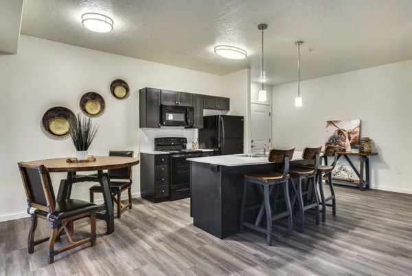 Dining area featuring modern design and elegant lighting at Central Park Commons Apartments