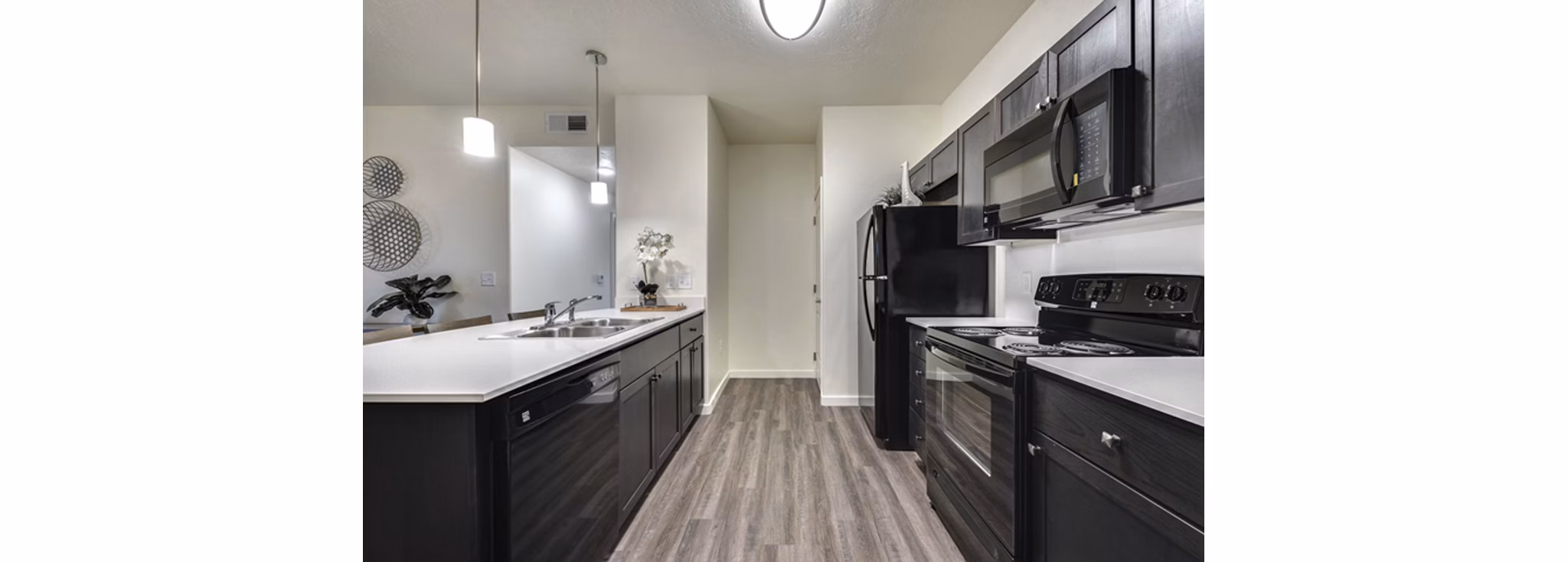 Kitchens with stainless steel appliances and marble countertops in Central Park Commons Apartments