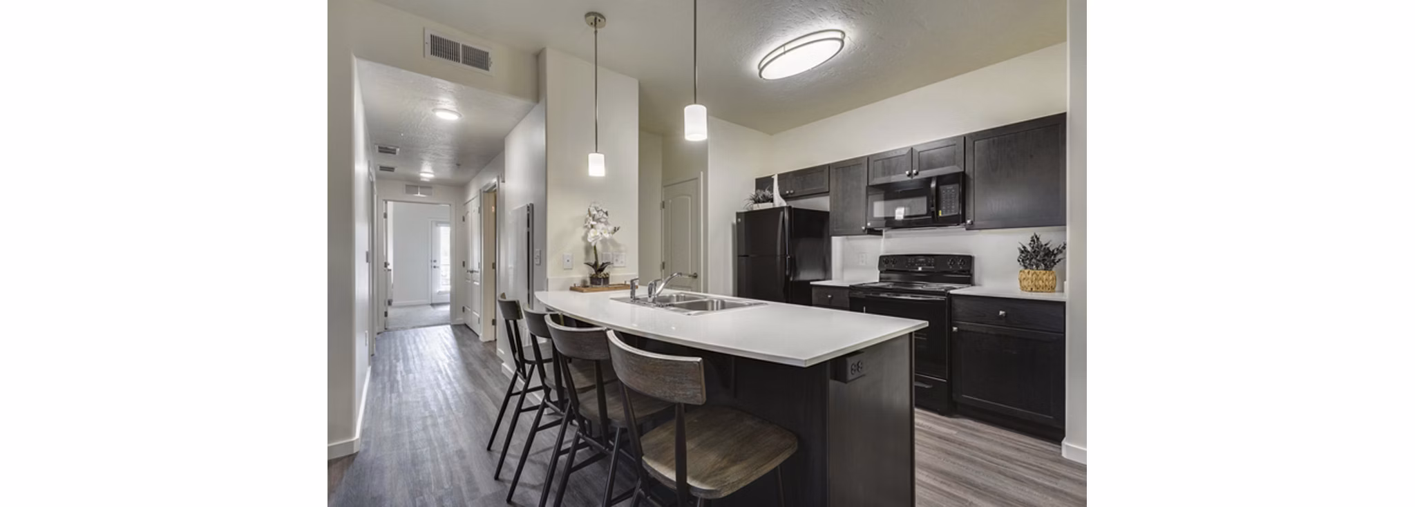 Modern kitchen with stainless steel appliances at Central Park Commons Apartments