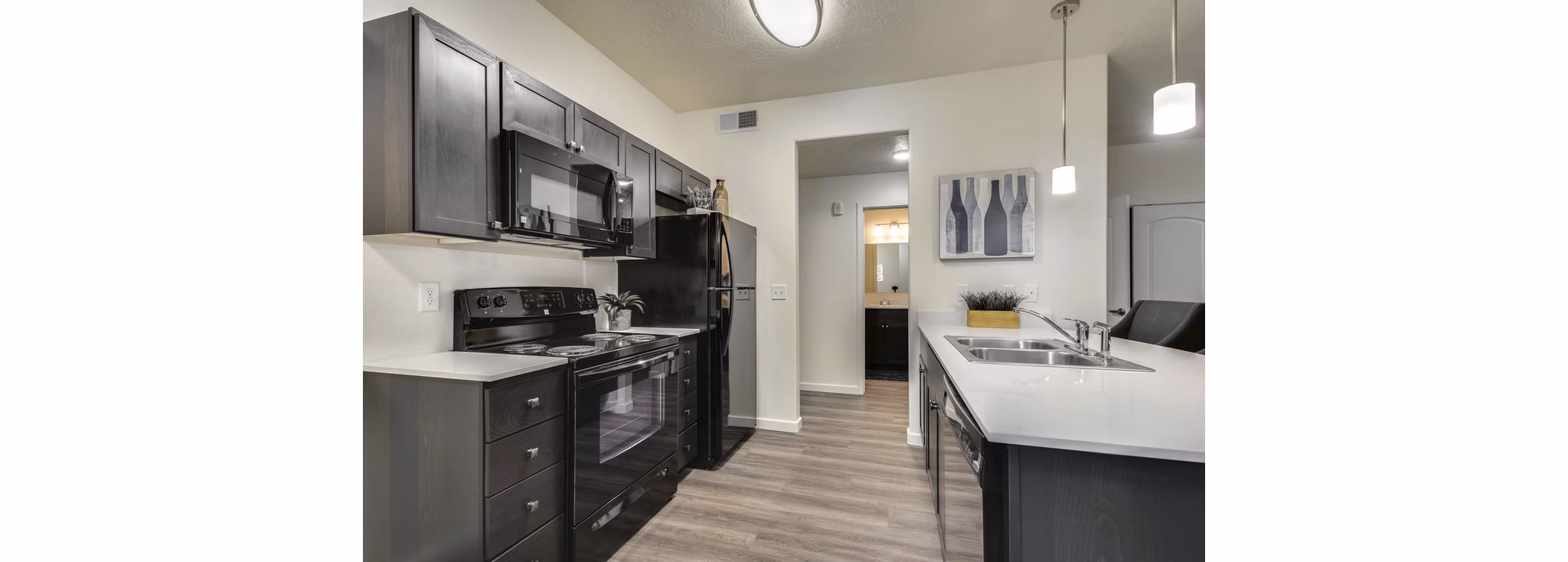 Modern kitchen with stainless steel appliances at Central Park Commons Apartments