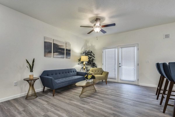 Spacious living room with modern decor in Central Park Commons Apartments