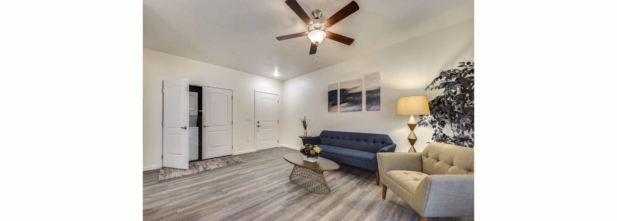 Cozy living room with contemporary decor and ample natural light in Central Park Commons Apartments
