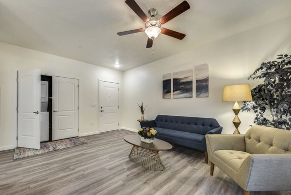 Cozy living room with contemporary decor and ample natural light in Central Park Commons Apartments