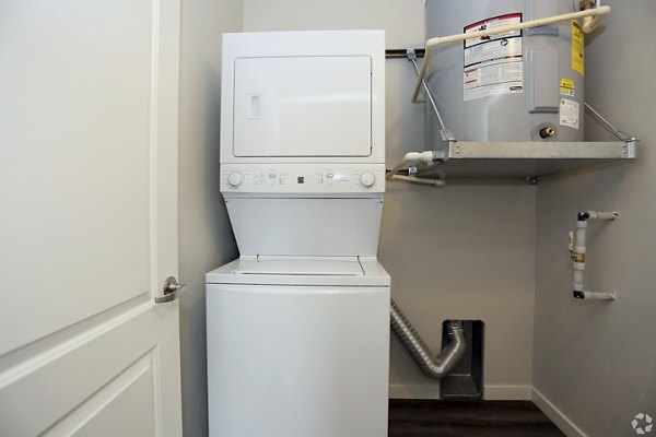 Laundry room with modern appliances in Central Park Commons Apartments