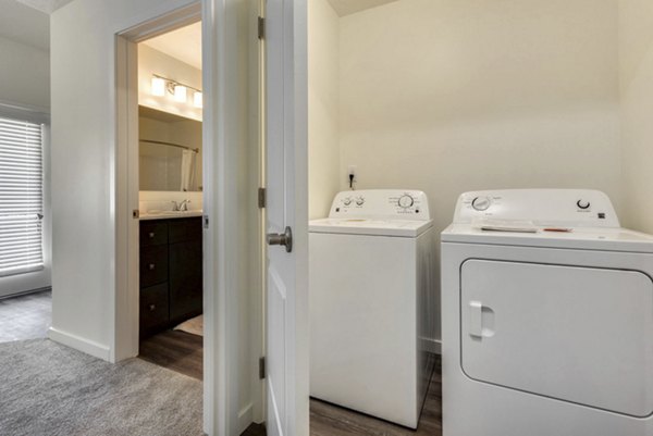 Laundry room with state-of-the-art appliances at Central Park Commons Apartments