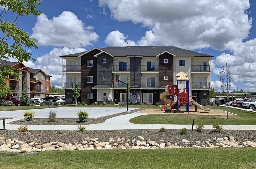 Colorful modern playground at Central Park Commons Apartments, perfect for family fun and outdoor play