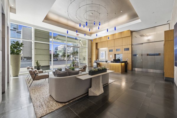 Clubhouse featuring modern design and cozy seating at 717 Olympic Apartments in Los Angeles