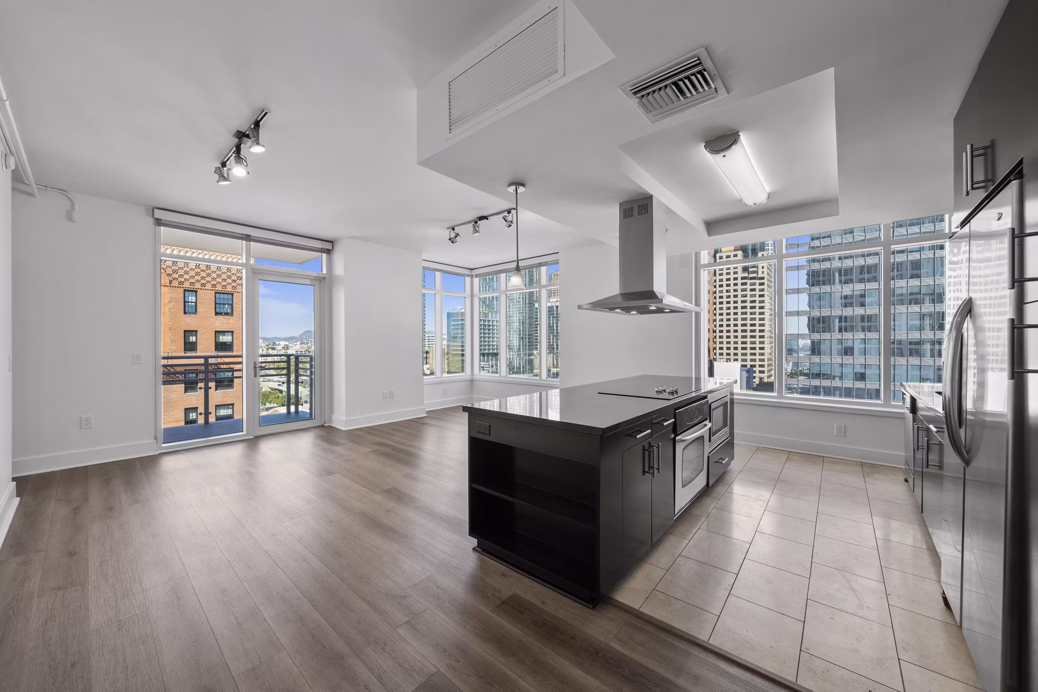 Open-concept kitchen with modern appliances at 717 Olympic Apartments