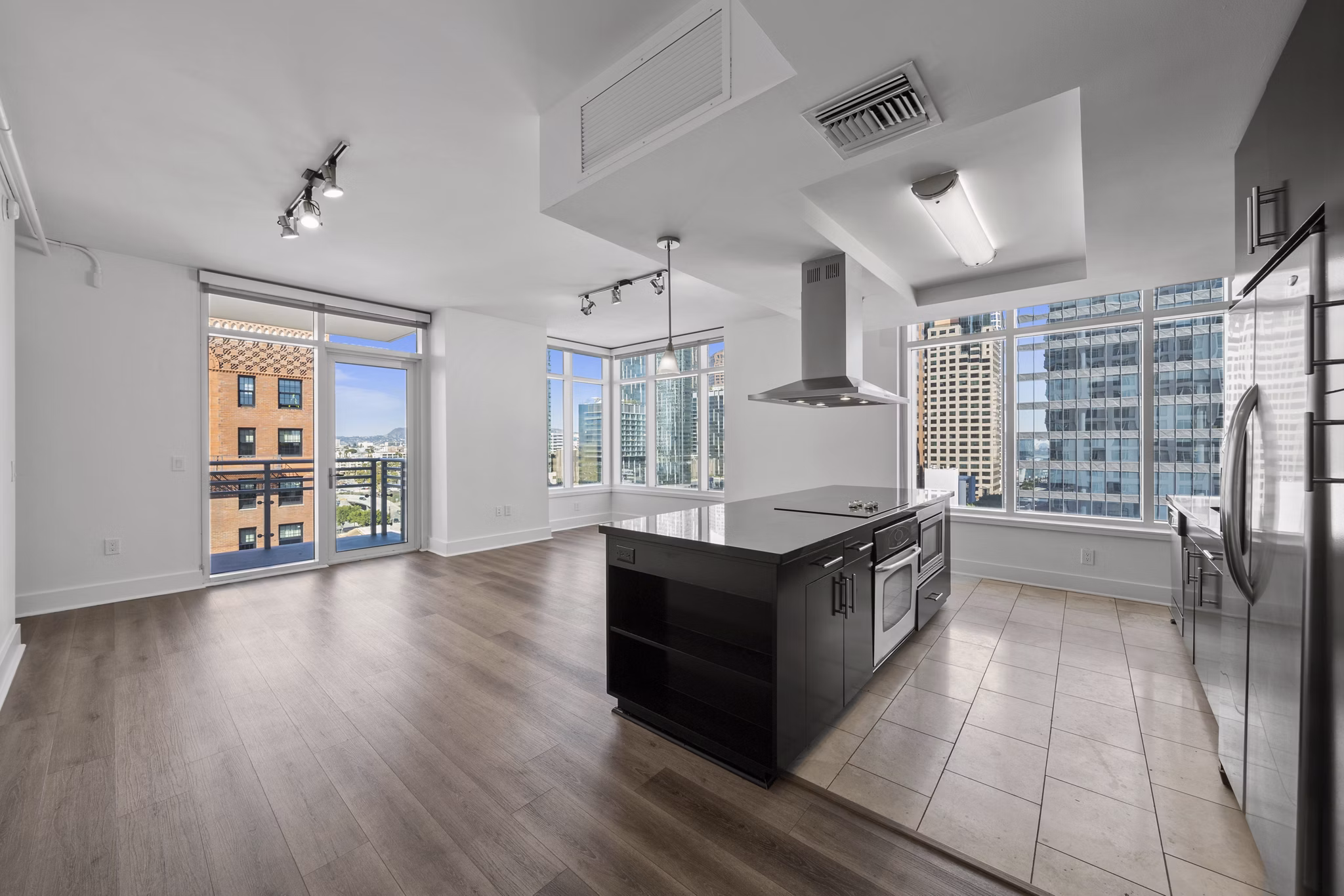 Open-concept kitchen with modern appliances at 717 Olympic Apartments