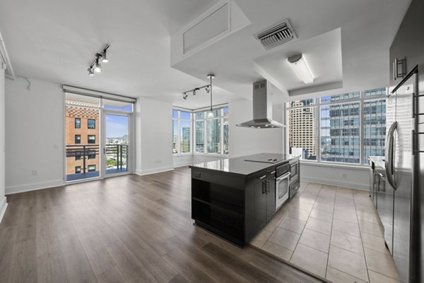 Open-concept kitchen with modern appliances at 717 Olympic Apartments
