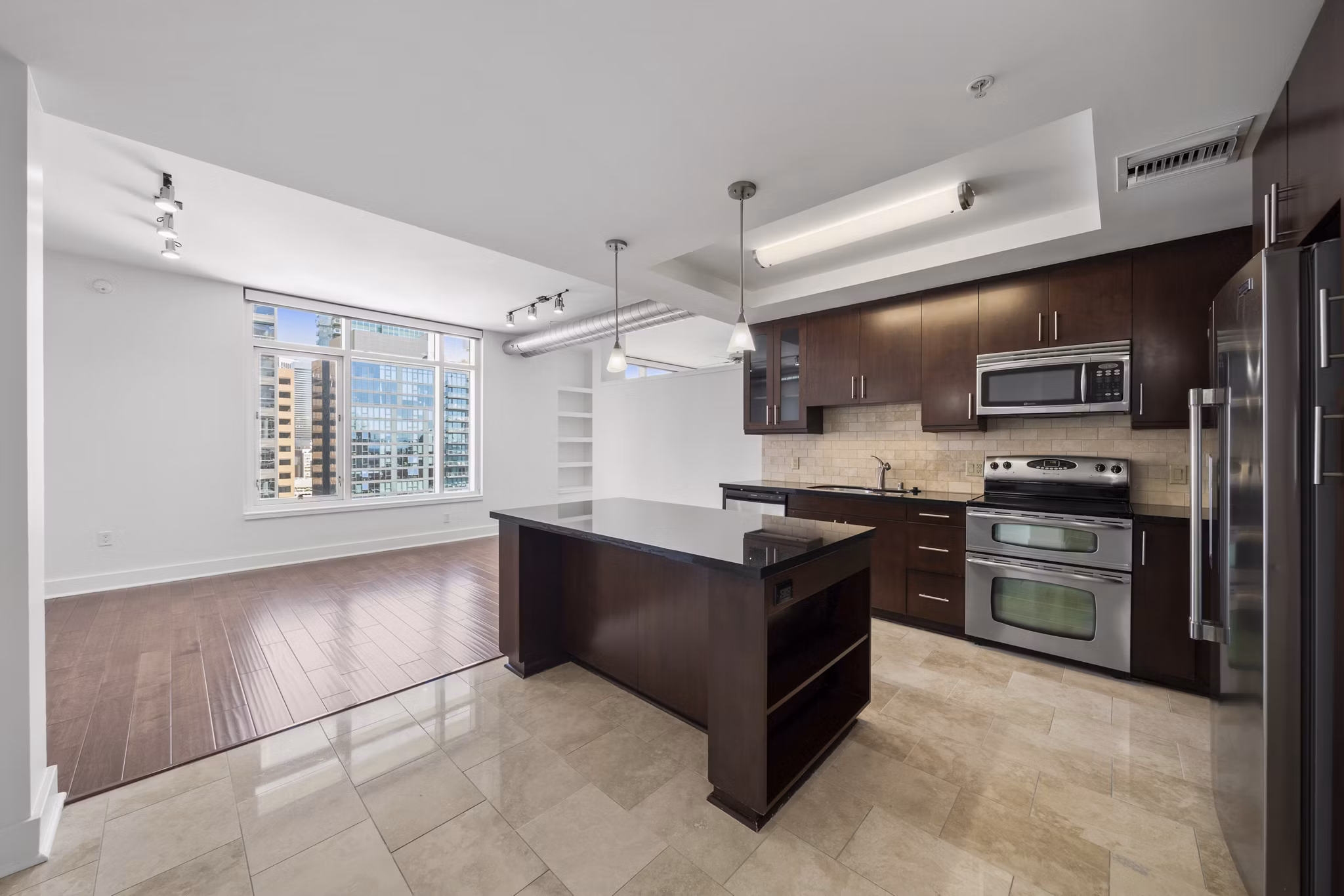 Modern kitchen with stainless steel appliances at 717 Olympic Apartments, luxury living in the heart of the city