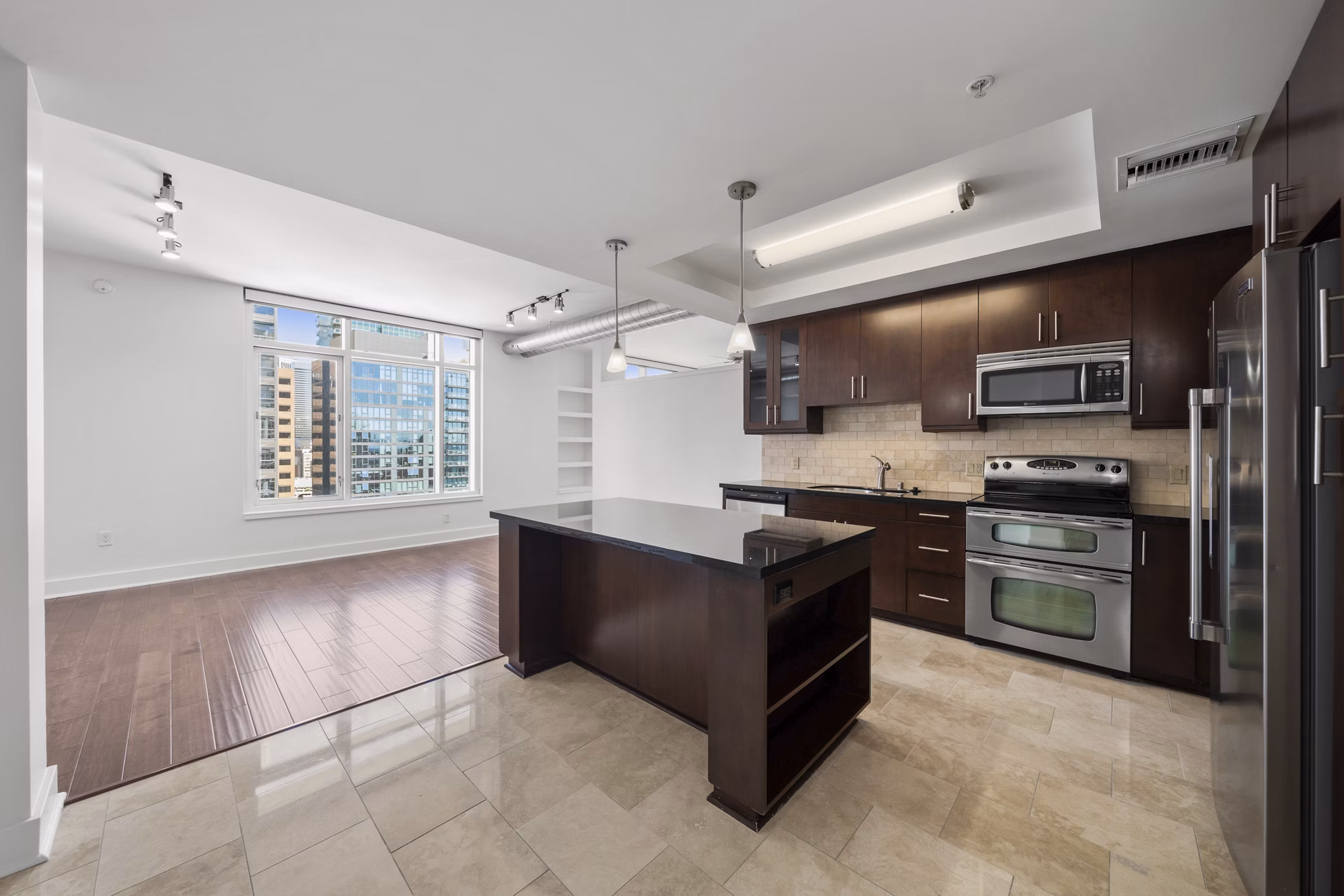 Modern kitchen with stainless steel appliances at 717 Olympic Apartments, luxury living in the heart of the city