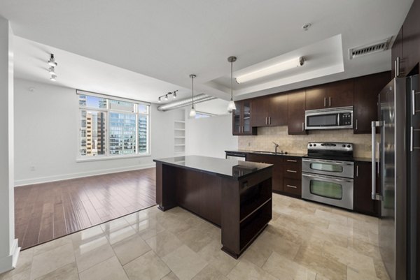 Modern kitchen with stainless steel appliances at 717 Olympic Apartments, luxury living in the heart of the city